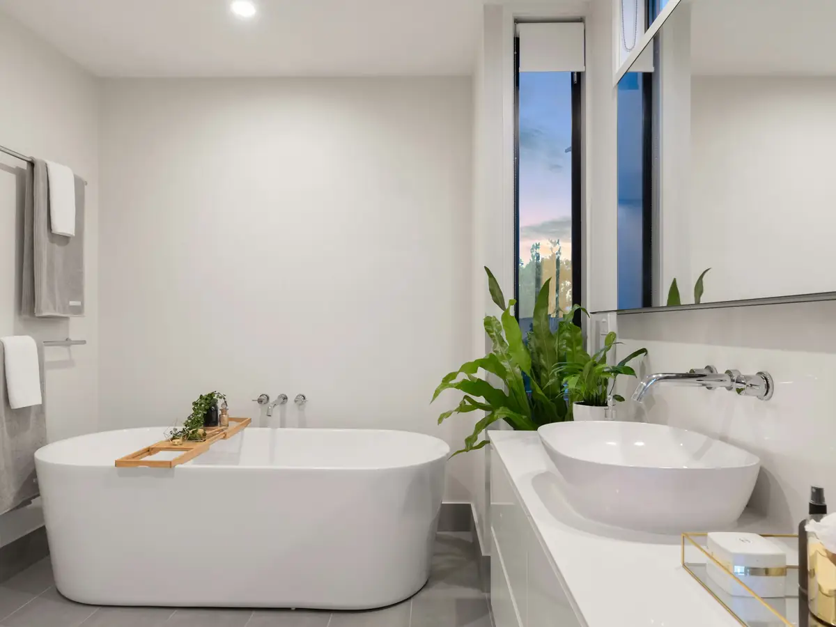 After: a white bathroom with a freestanding tub