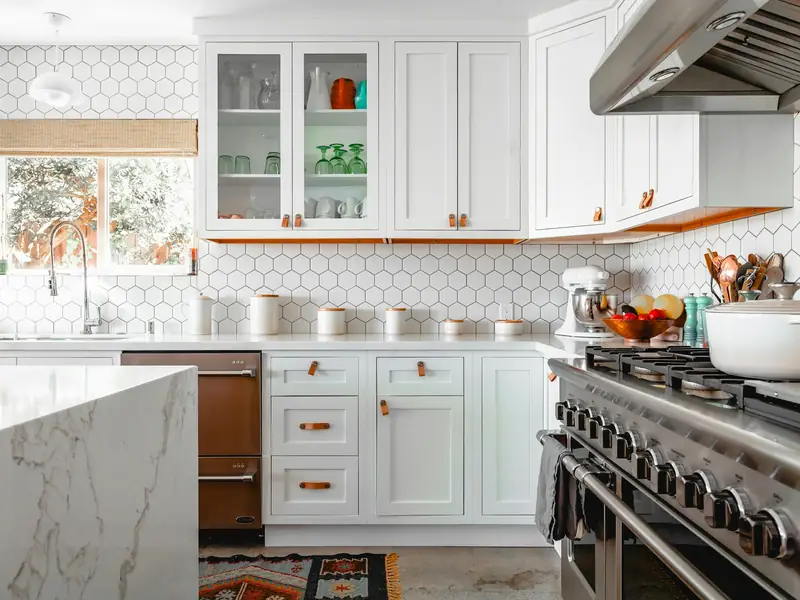 A new kitchen with white cabinets and hexagonal tiles